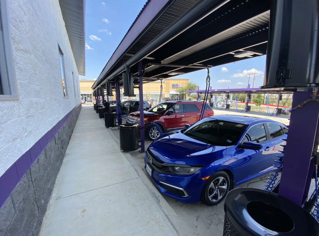 A popular Feel Great Car Wash location with a bunch of cars getting serviced