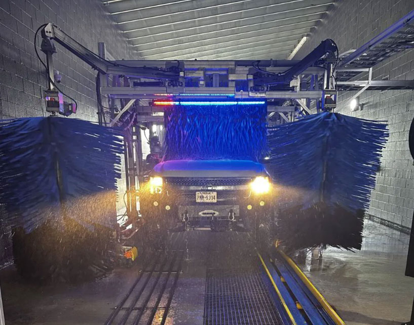 A truck going through a car wash at Feel Great Car Wash