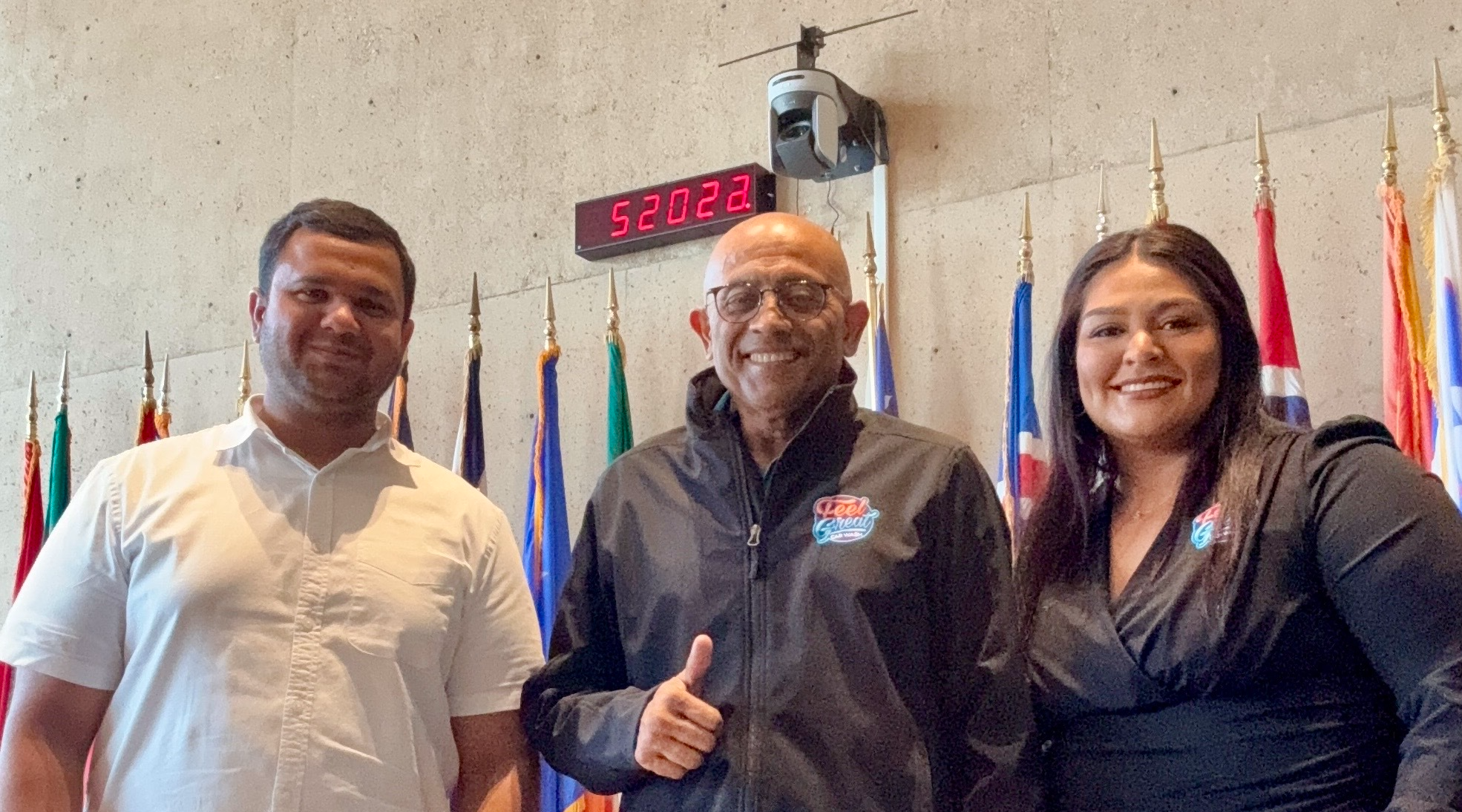 Team member posing for a photo op at the city of dallas council meeting for a new car wash